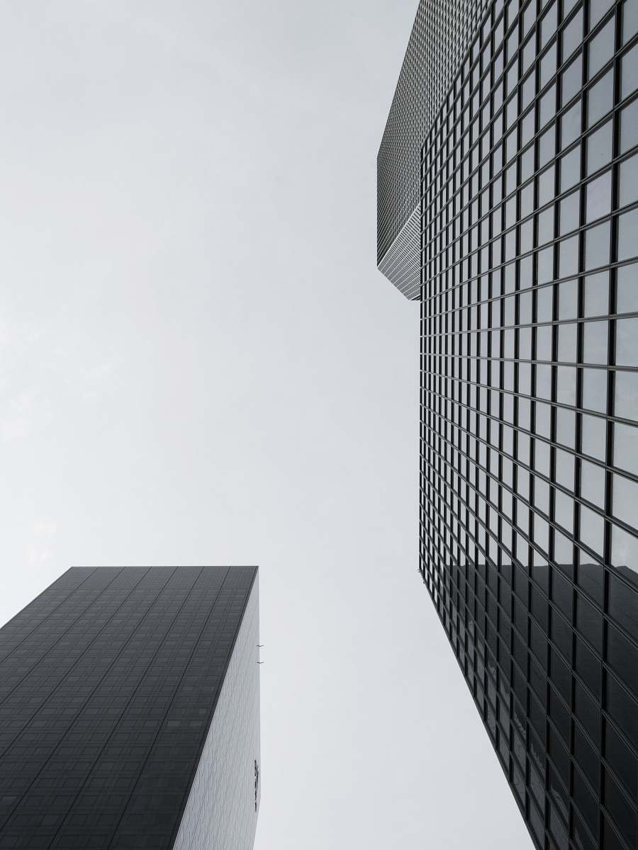 office building low angle photography of glass high rise building grey